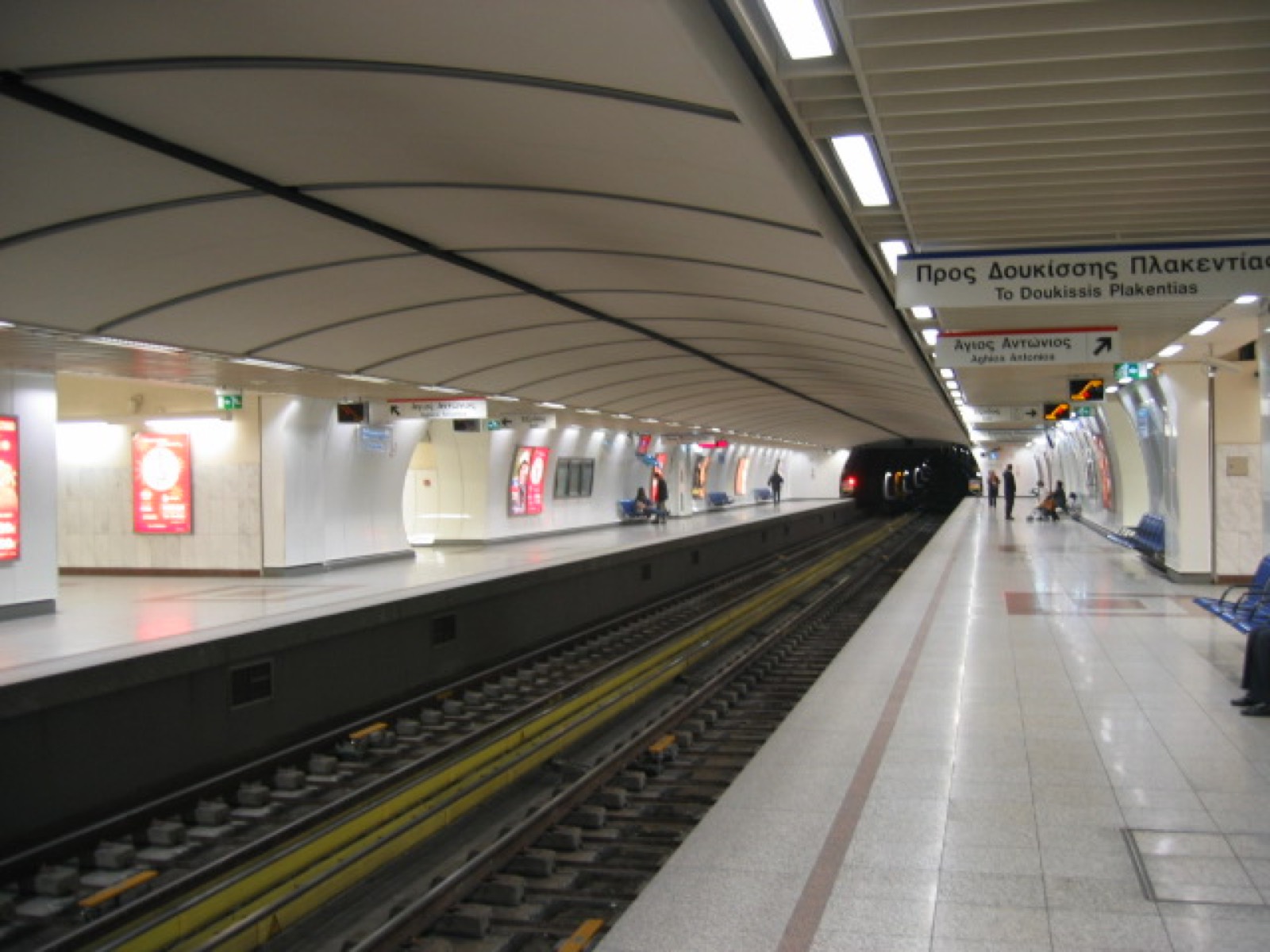 An Athens metro platform with an arriving train